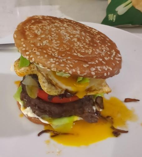 A hamburger, overflowing with toppings