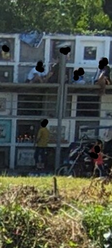 'Apartment-Style' Cemetary with people, rows of concrete and floors of mourning