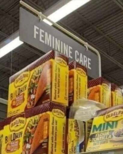 A picture of the "Feminine Care" section of a supermarket. The section contains Taco Dinner Build Kits.