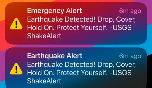 A phone screencap of two emergency alerts that say “ Earthquake Detected! Drop, Cover, Hold On. Protect Yourself. -USGS ShakeAlert”
