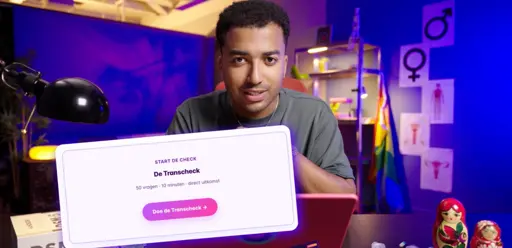 A guy, suggested to be the creator of the article, is sitting in a cubicle with a laptop in front of him. A rainbow flag is set up behind him, and A4-printed out paper with the icon for male and female, as well as imagery depicting genitals in a clinical fashion are on the wall behind him. An insert shows one of the websites mentioned in the article.